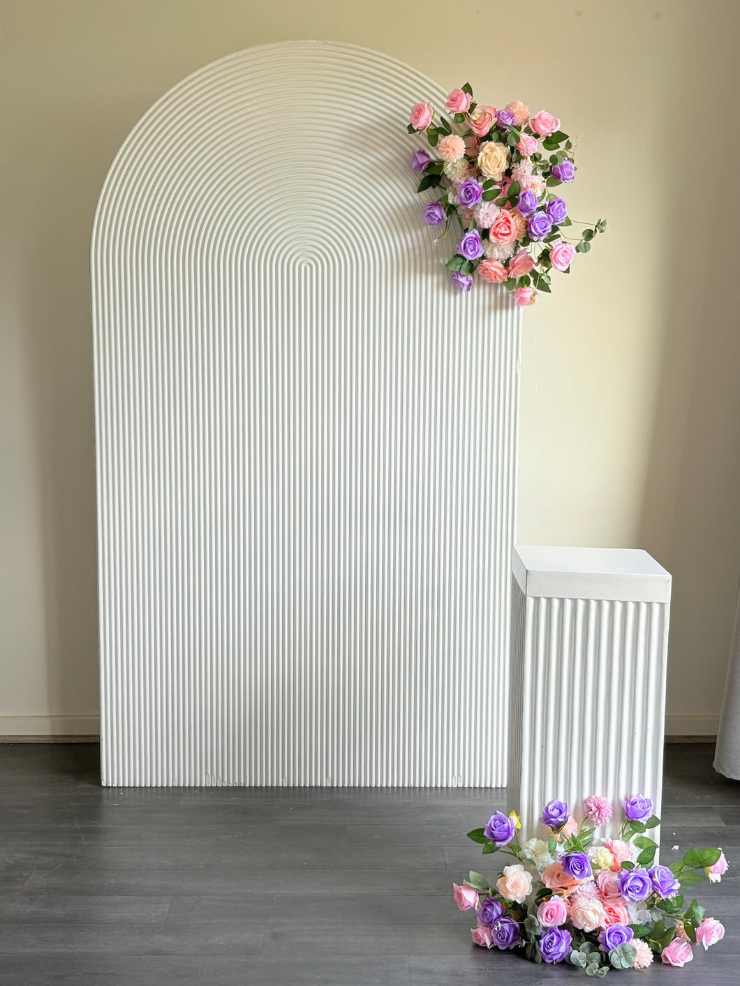 Package Hire includes 1 wooden ripple backdrop 2.15m H x 1.2m W +1 plinth + 2 flowers