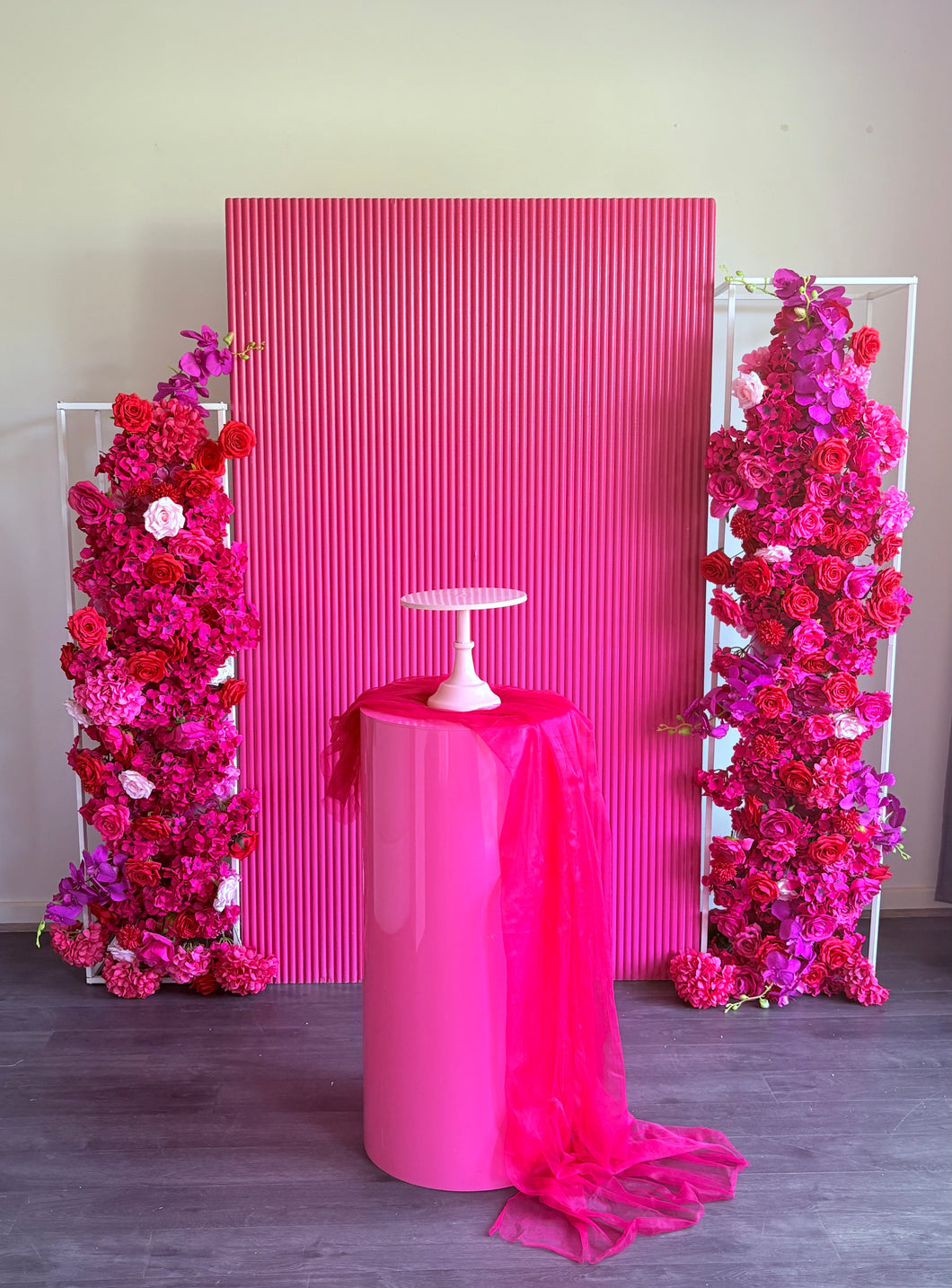 Package Hire includes 1 wooden ripple backdrop 2mH x 1.2m W +1 plinth + 2 flowers