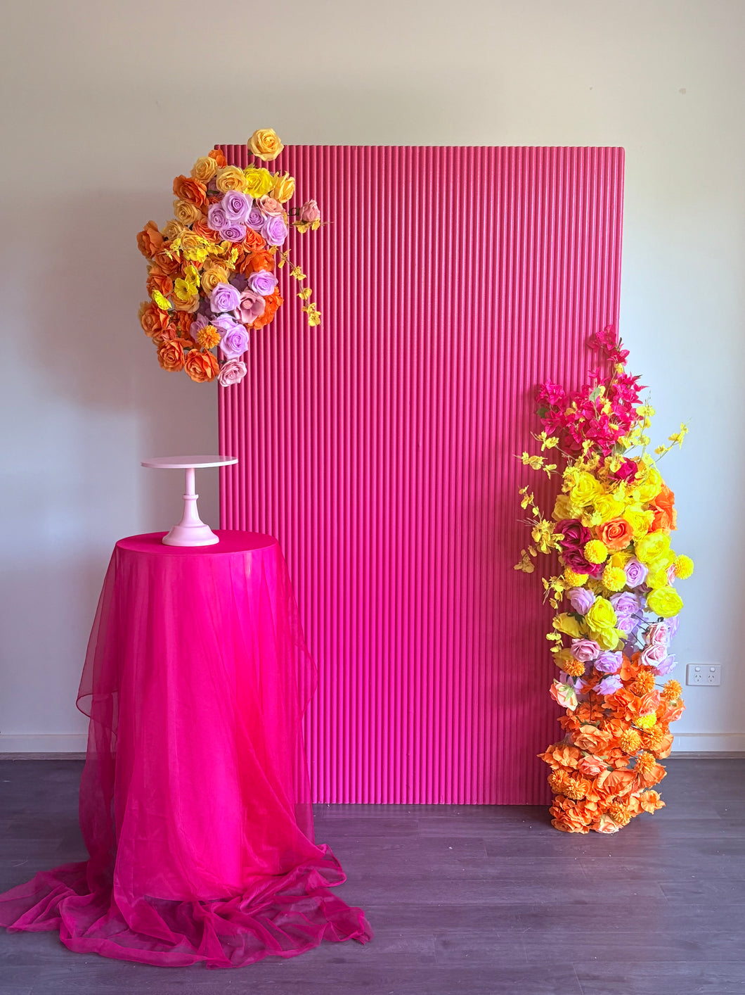 Package Hire includes 1 wooden ripple backdrop 2mH x 1.2m W +1 plinth + 2 flowers