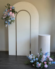 Load image into Gallery viewer, Package Hire includes 1 wooden backdrop 2.15cm h x 1.2m w + 1 ripple plinth + 2 flowers
