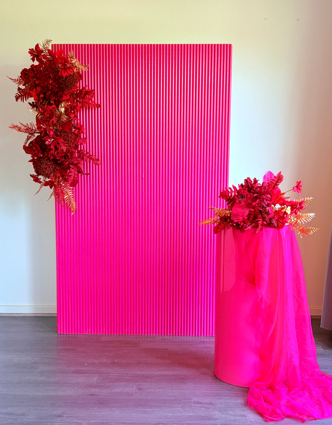Package Hire includes 1 wooden ripple backdrop 2mH x 1.2m W +1 plinth + 3 flowers