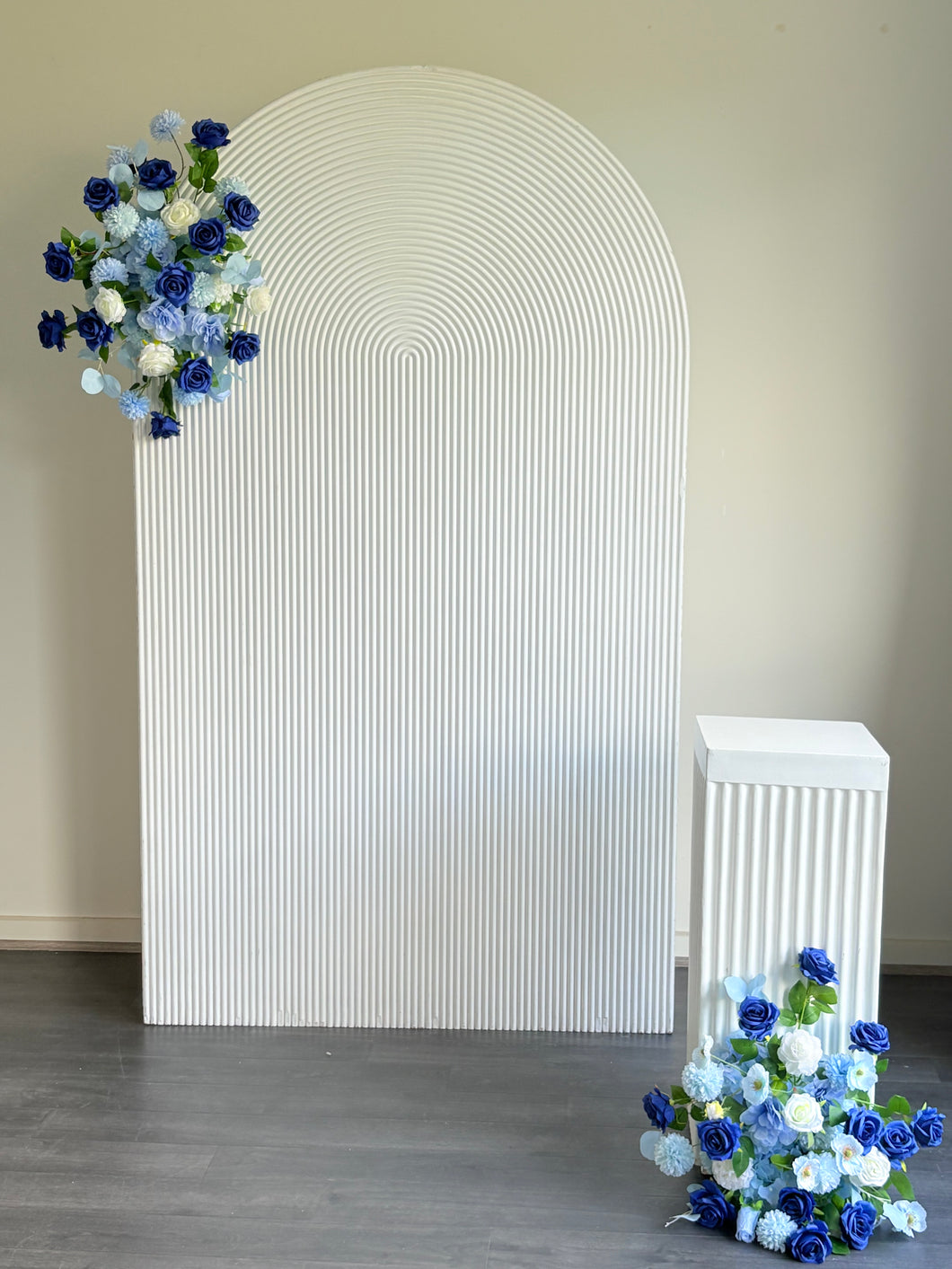 Package Hire includes 1 wooden ripple backdrop 2.15m H x 1.2m W +1 plinth + 2 flowers